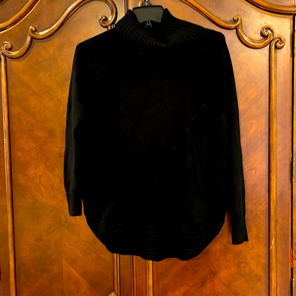 Black turtleneck sweater with gold side zippers